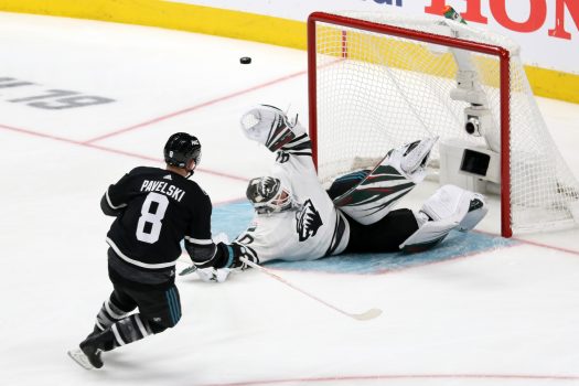 Central goalie Devan Dubnyk makes a sprawling save on a shot by Joe Pavelski