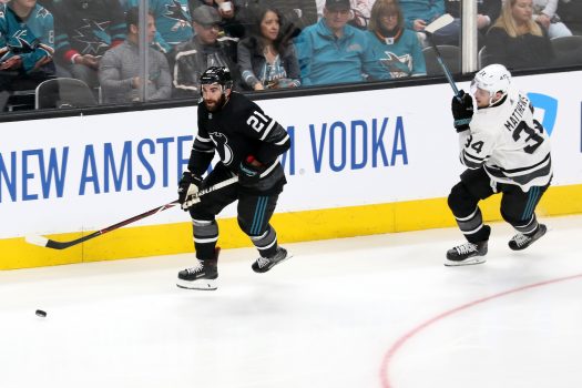 Kyle Palmieri (21) moves the puck up ice past Auston Matthews