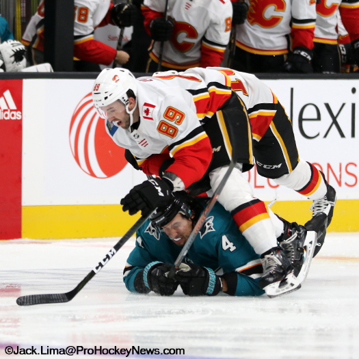 Flames forward Alan Quine (89) collides with Sharks defenceman Brenden Dillon (4)