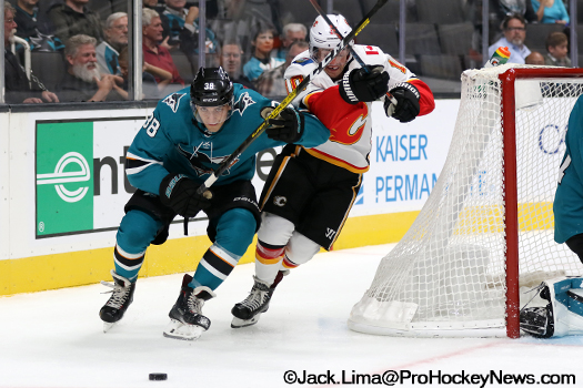 Mario Ferraro (38) and Derek Ryan (10) fight for the puck