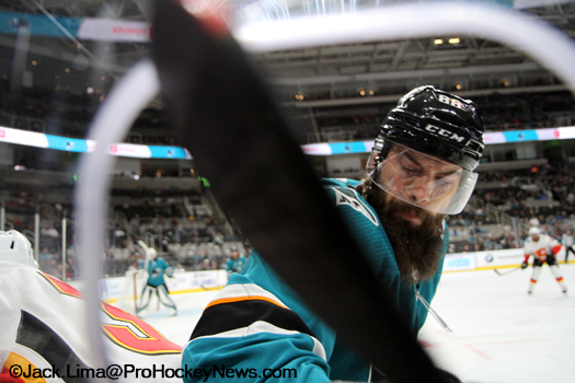 Sharks defenceman Brent Burns attempts a body check