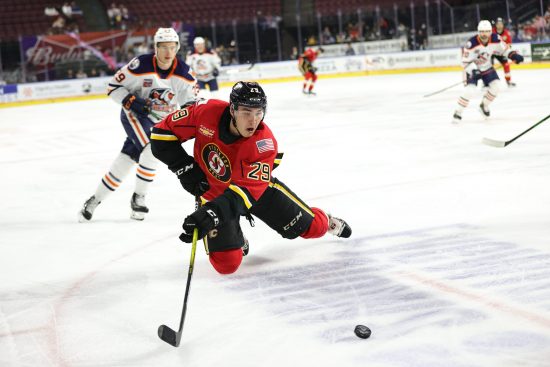 Adam Ruzicka skates with puck