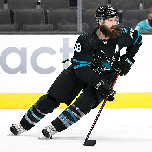 Brent Burns (88) controls the puck as he looks up ice