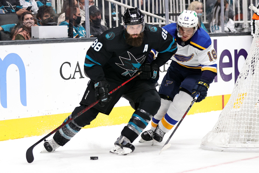 Brent Burns (88) skates the puck up ice as Robert Thomas (18) defends