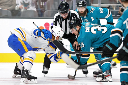 Linesman Vaughan Rody drops the puck as Cody Eakin (Left) and Logan Couture (39) face-off - Photo by Jack Lima