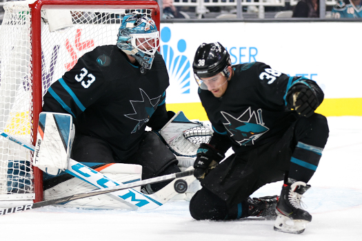 Mario Ferraro (38) looks to control a rebound in front of goalie Adin Hill