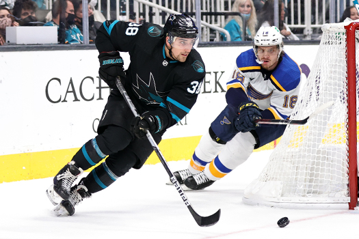 Mario Ferraro (38) moves the puck up ice as Robert Thomas (18) pursues