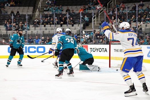 Rasmus Asplund (74) celebrates as Jeff Skinners shot (not pictured) eludes Sharks goalie James Reimer for a goal