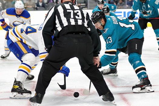 Sabres center Dylan Cozens (Left) battles Sharks center Nick Bolino (13) in the face-off circle