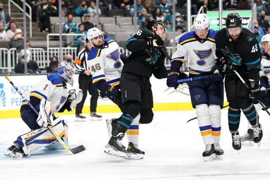 Sharks Jasper Weatherby (center) and Jonah Gadjovich (42) try to avoid a shot on goal