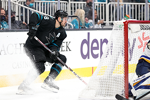 Tomas Hertl controls the puck behind the net