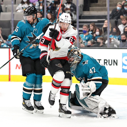 Tyler Ennis (63) looks to screen Sharks Goalie James Reimer as Erik Karlsson (65) defends
