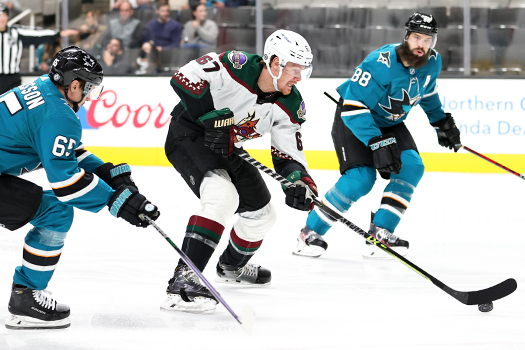 Larson Crouse (67) moves in for a shot attempt as Erik Karlsson (65) and Brent Burns (88) defend