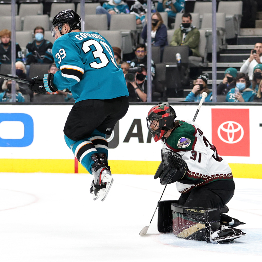 Logan Couture (39) jumps to avoid a shot in front of Coyotes' goalie Scott Wedgewood during overtime action