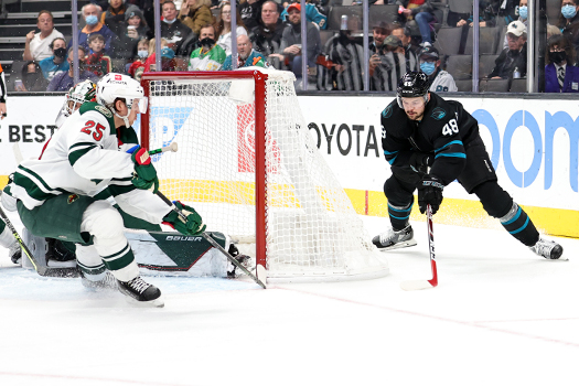 Tomas Hertl (48) attempts a wrap-around goal, as Jonas Brodin (25) defends - Photo by Jack Lima