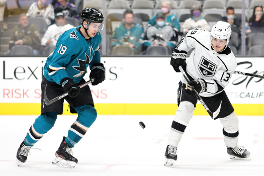 Lane Pederson (18) and Alex Turcotte (39) look to control the puck