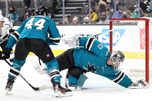 Sharks' goalie James Reimer covers the puck as Marc-Edouard Vlasic looks to help