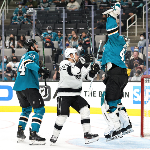 Sharks' goalie James Reimer jumps to catch the puck as Victor Arvidsson (33) and Jaycob Megna (24) look on