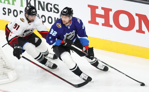 Evgeny Kruznetsov (92) looks to pass as Nazem Kadri (91) defends