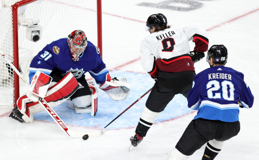 Frederik Anderson (31) stops a shot from Clayton Keller (9) as Chris Kreider (20 defends