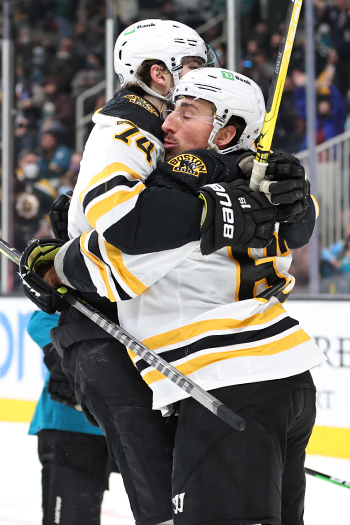 Jake DeBruusk (74) hugs Brad Marchand after his second period goal