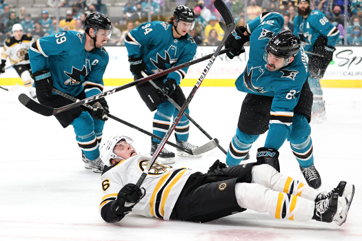 Mike Reilly (6) is checked to the ice by Jacob Middleton (21)