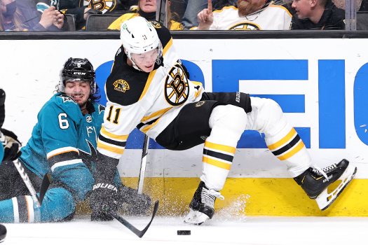 Ryan Merkley (6) and Trent Frederic (11) battle for the puck