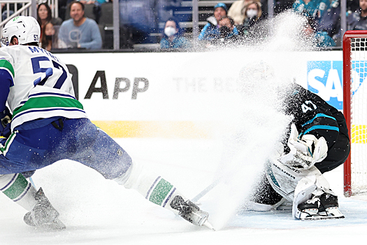Sharks goalie James Reimer receives a snow shower from Tyler Myers (57) - Photo by Jack Lima