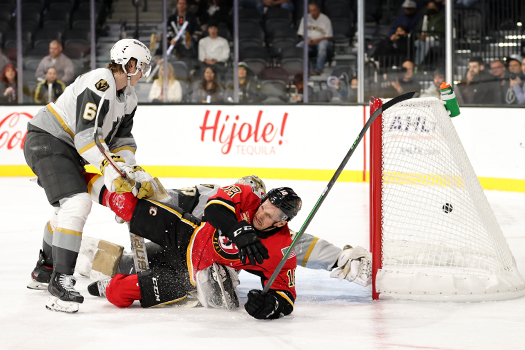 Byron Froese (18) falls to the ice as Emillio Pettersens' (not pictured) shot eludes goalie Jiri Patera for the Heat's second goal - Photo by Jack Lima