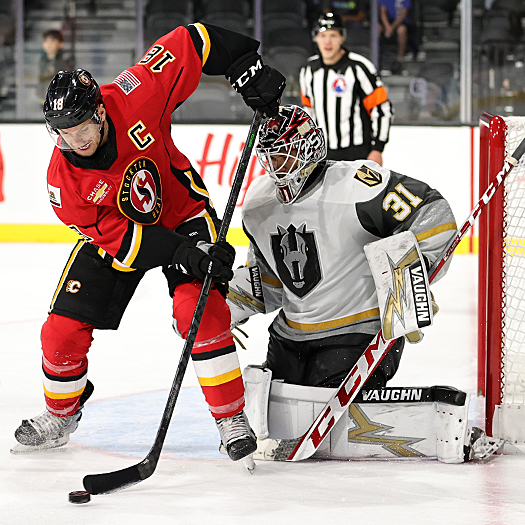 Byron Froese (18) tries to tip a shot past Silver Knights' goalie Isaiah Saville