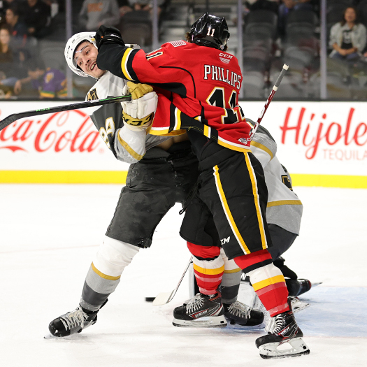 Matthew Phillips (11) fights with Brayden Pachal for position in front of the net
