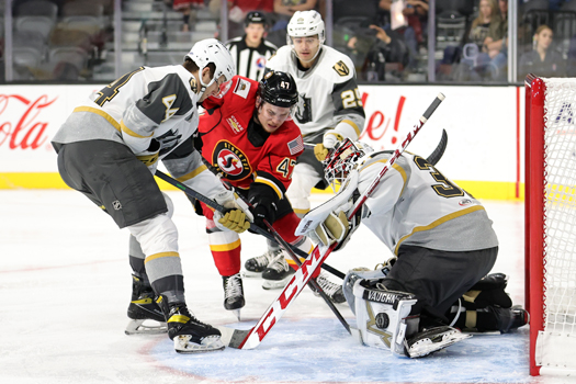 Silver Knights' goalie Isaiah Saville stops a shot by Connor Zary (47) as Layton Ahac (44) defends