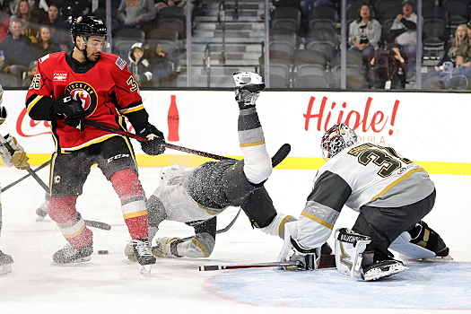 Tyrell Goulbourne (36) collides with Brayden Pachal in front of the net