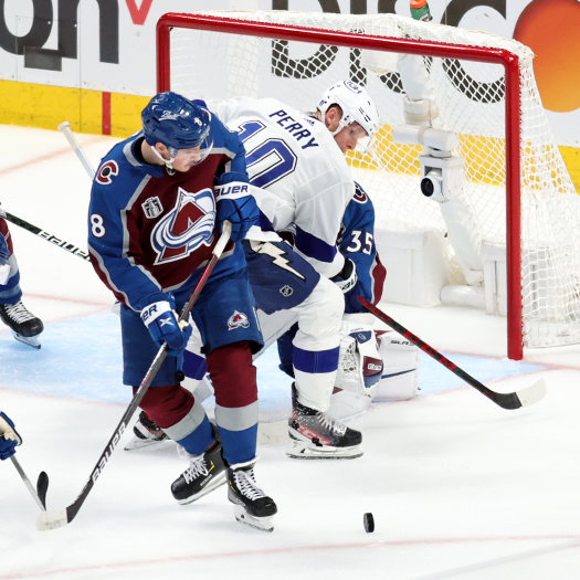 Cale Makar (8) and Corey Perry (10) look for a rebound