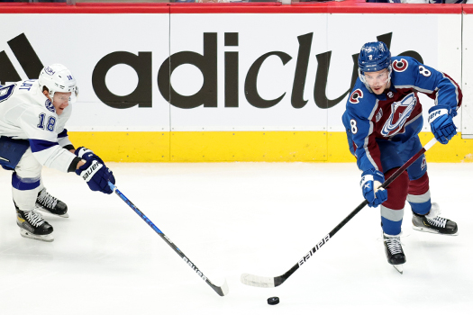 Cale Makar (8) makes a pass as Ondrej Palat (18) defends