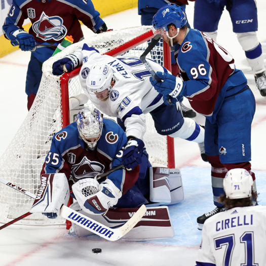 Corey Perry (10) falls over goalie Darcy Kuemper as he attempts to cover the puck