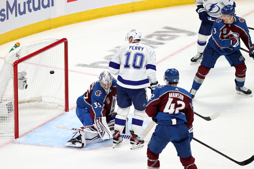 Corey Perry (10) watches Nikita Kucherov's (not pictured) shot elude Avalanche goalie Darcy Kuemper for a goal during second period action