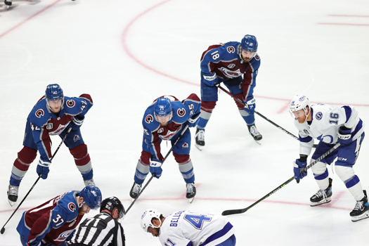 Josh Manson (42) Logan O'Connor (25) Alex Newhook (18) and Riley Nash (16) line up for a face-off
