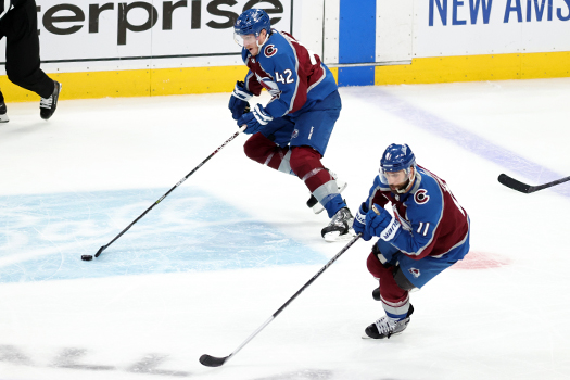Josh Manson (42) leads a rush up ice with Andrew Cogliano (11)