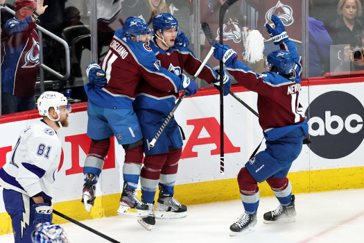Josh Manson (center) celebrates his first period goal with Andrew Cogliano (11) and Alex Newhook (18)