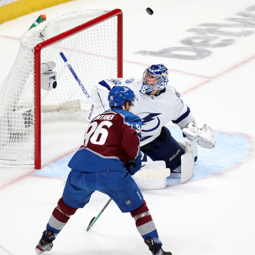 Lightning goalie Andrei Vasilevskiy looks for the puck after making a save as Mikko Rantanen (96) looks for a rebound
