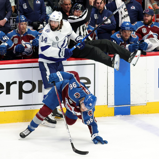 Linesman Jonny Murray falls into the bench to avoid a collision with Pat Maroon (14)