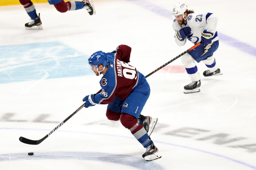 Mikko Rantanen (96) skates the puck up ice as Brayden Point (41) pursues