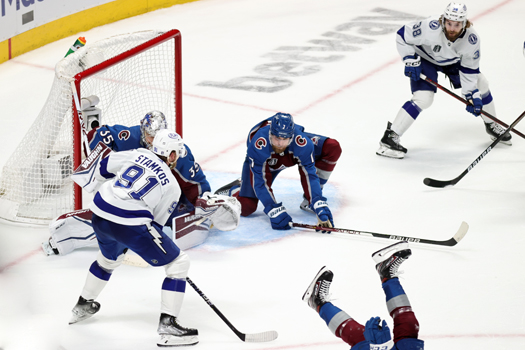 Steven Stamkos (91) looks to pass to Brandon Hagel (38) as defenseman Jack Johnson (3) gets his stick in the passing lane