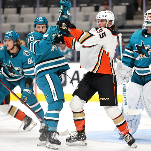Andrew Agozzino (26) battles Josh Lopina (85) for position in front of the net
