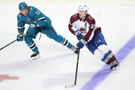 Ben Meyers (59) skates the puck up ice as Tristen Robins (52) defends