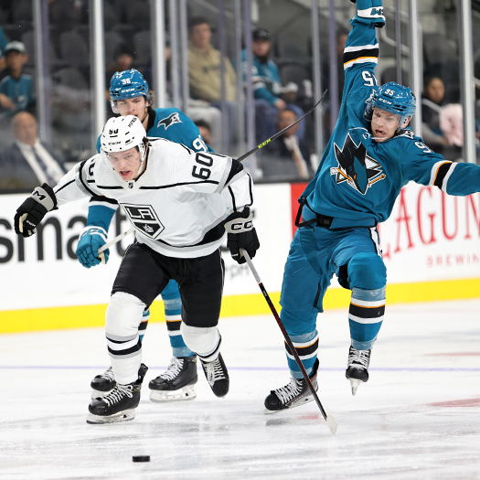 James Stefan (60) splits defencemen Samuel Mayer (96) and Mitchell Smith (95)