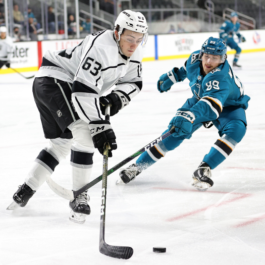 Landon Kosior (63) looks to control the puck as Ozzy Wiesblatt (89) applies pressure