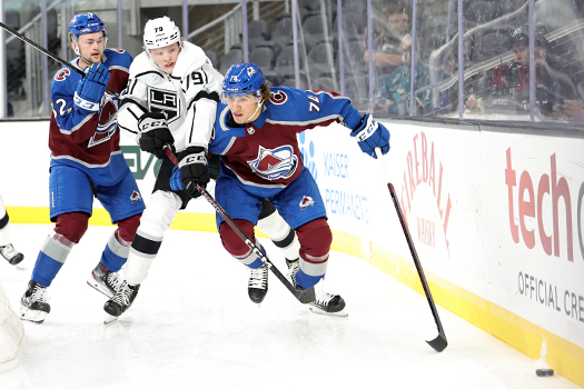 (Left-Right) Nolan Orzeck-Samuel Helenius and Alex Beaucage fight for the puck in back of the net