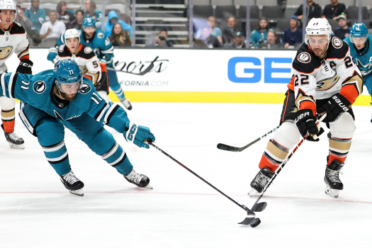 Luke Kunin (11) and Kevin Shattenkirk (22) battle for a loose puck